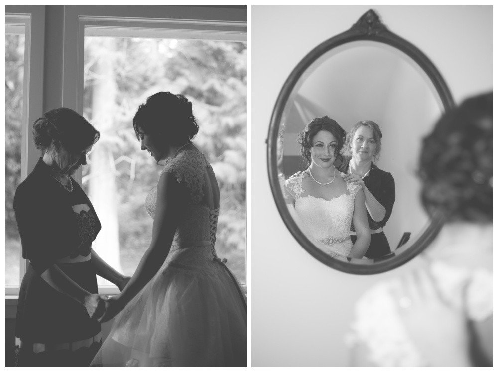 Black and white image of a bride sharing a special moment with her mom before the wedding 