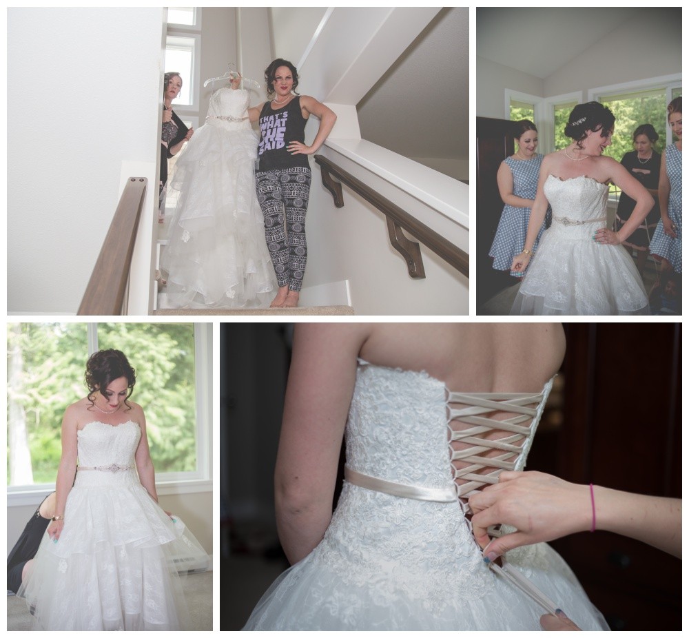 Bride gets help putting on her gown from her bridesmaids 